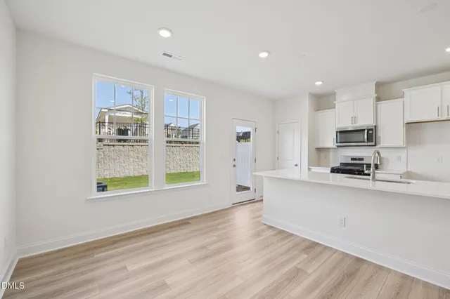 a view of an entryway with wooden floor