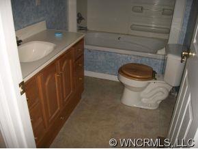 995 Painters Gap Road Rutherfordton, NC 28139 - Photo 4 of 5 a bathroom with a granite countertop sink and a toilet