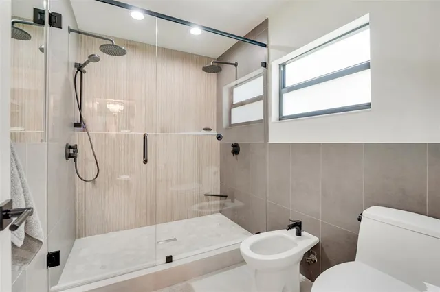 a bathroom with a toilet sink and shower
