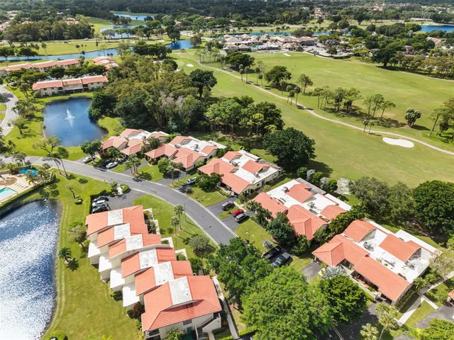 an aerial view of residential houses with outdoor space and river