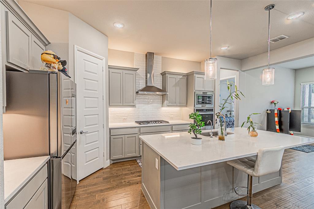 13261 Jonata Street Frisco, TX 75035 - Photo 15 of 40 a kitchen with a sink stainless steel appliances and white cabinets