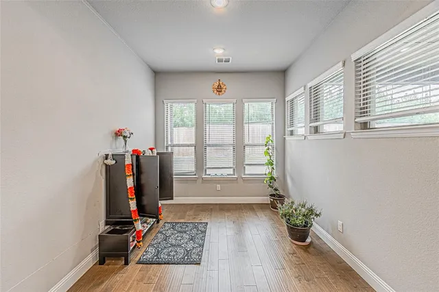 a view of an entryway with wooden floor