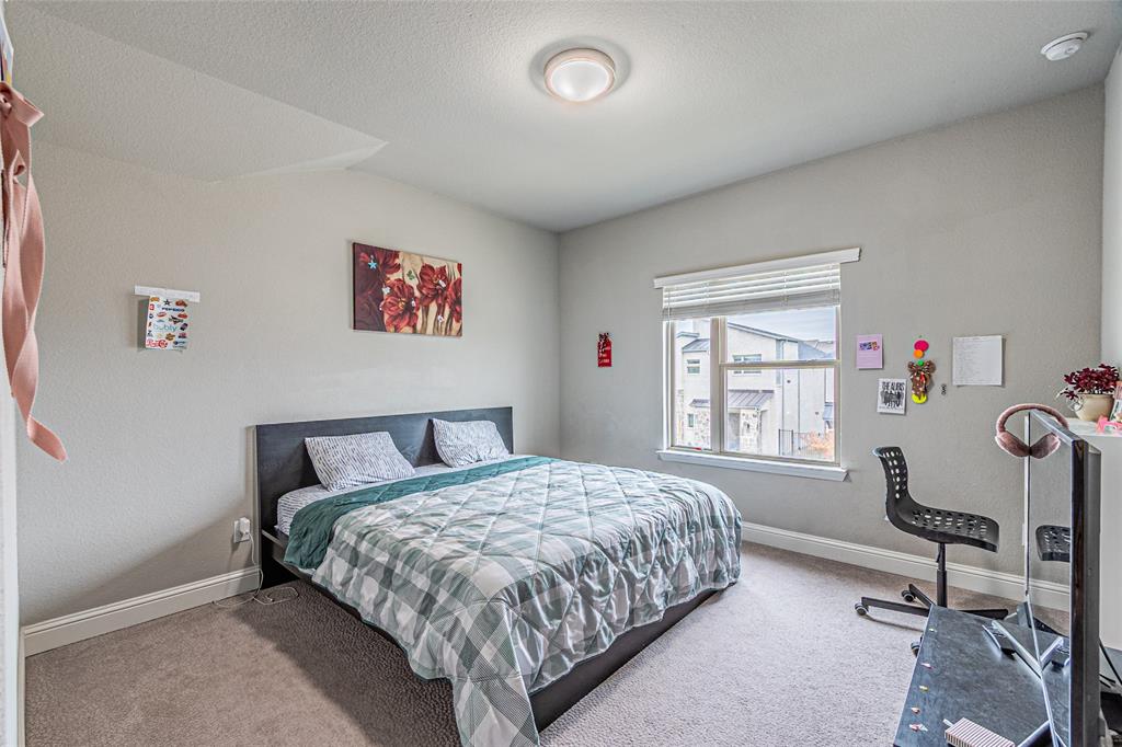 13261 Jonata Street Frisco, TX 75035 - Photo 27 of 40 a bedroom with a bed a chair and a large window