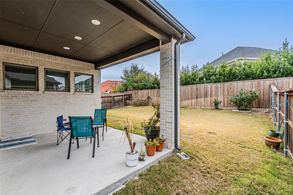 13261 Jonata Street Frisco, TX 75035 - Photo 37 of 40 a view of a patio with table and chairs a barbeque with wooden fence