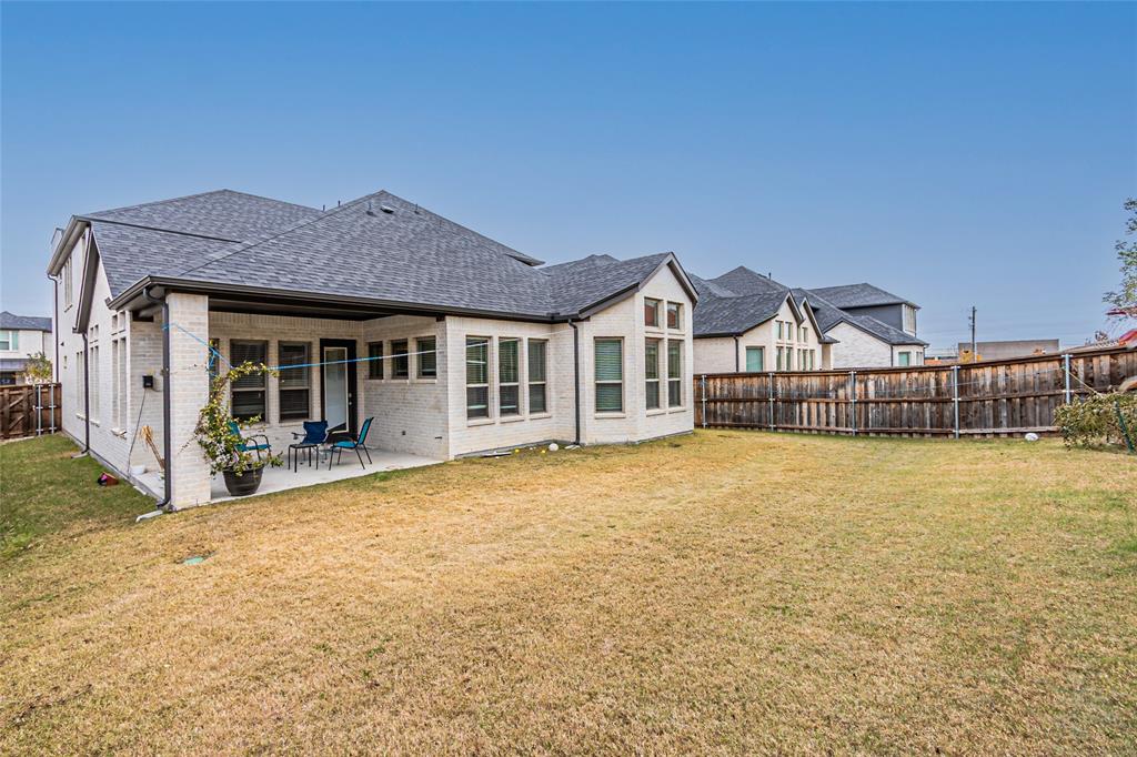 13261 Jonata Street Frisco, TX 75035 - Photo 38 of 40 a front view of a house with yard and glass windows