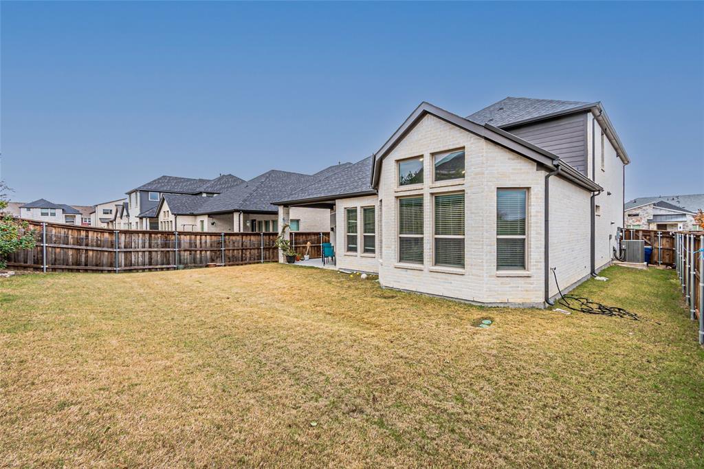 13261 Jonata Street Frisco, TX 75035 - Photo 40 of 40 a front view of a house with a yard