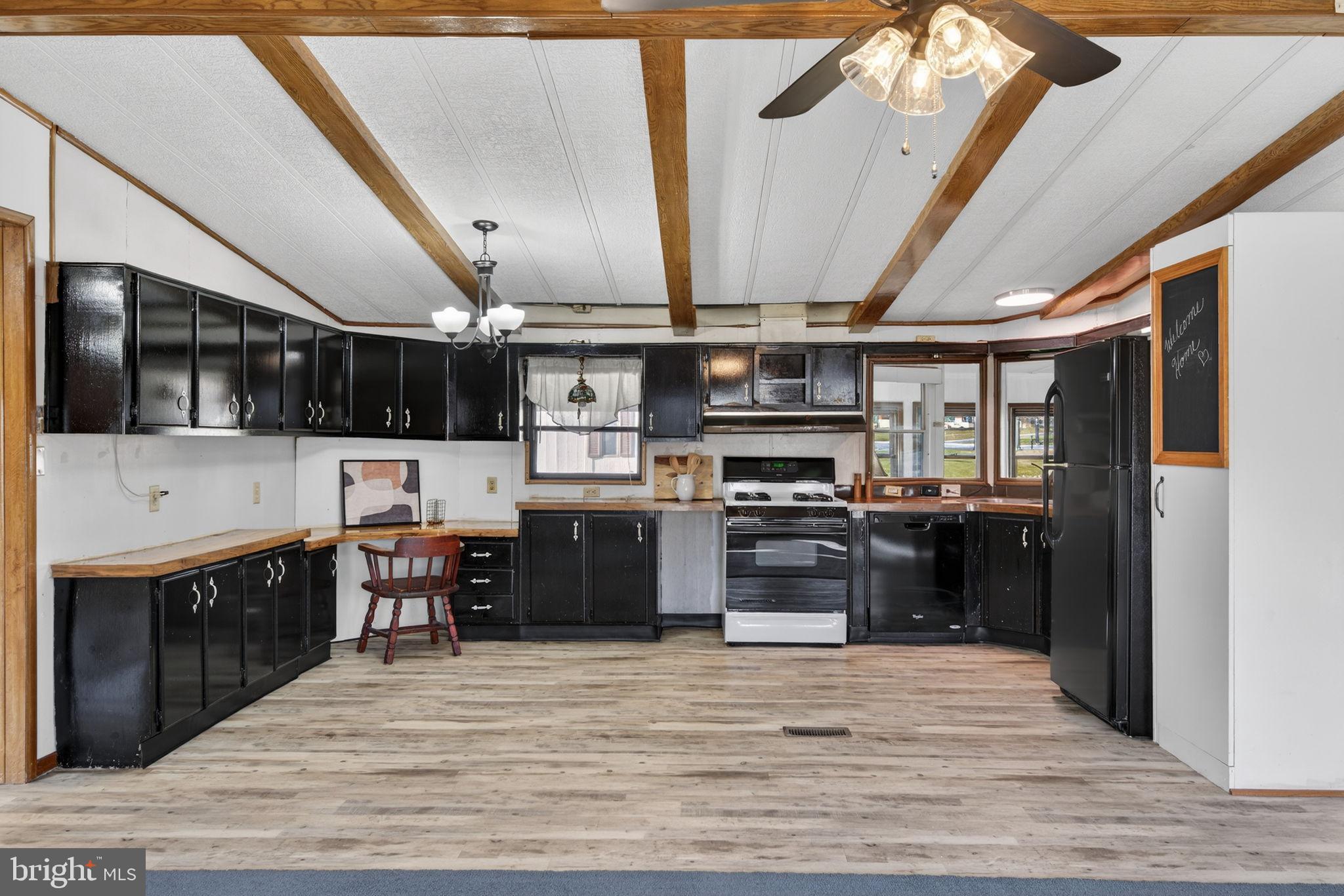 918 Krista Court Lancaster, PA 17601 - Photo 11 of 43 a kitchen with stainless steel appliances kitchen island granite countertop a refrigerator a sink dishwasher a stove and a refrigerator with wooden floor