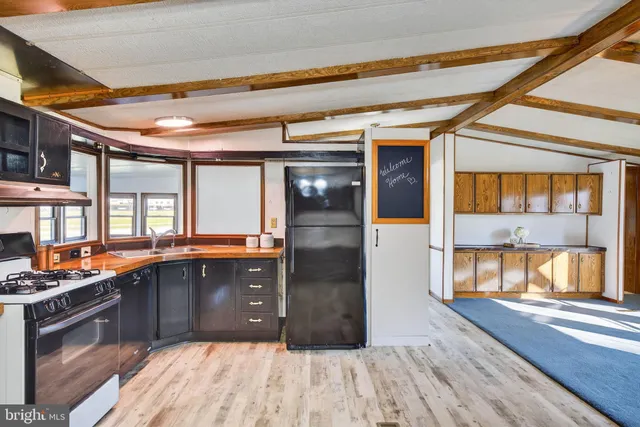 a kitchen with a sink and a large window