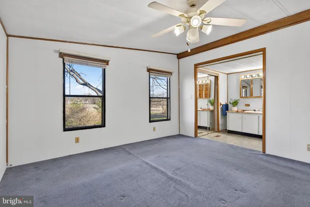 an empty room with windows and closet