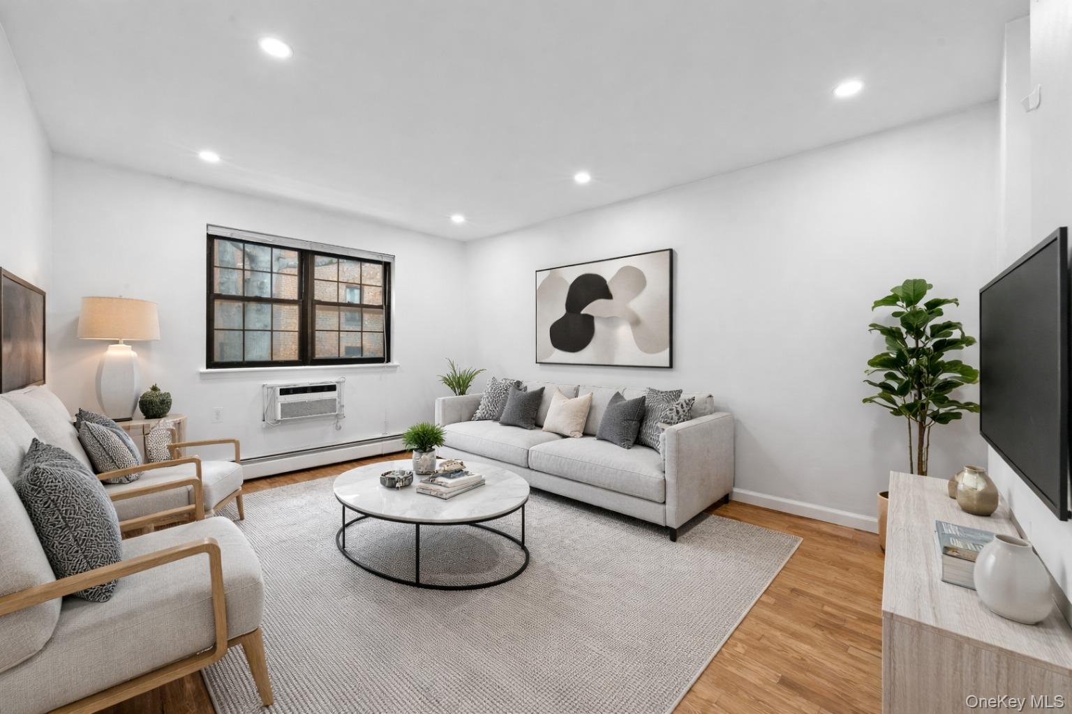84-30 98th Street Queens, NY 11421 - Photo 15 of 35 a living room with furniture and a potted plant