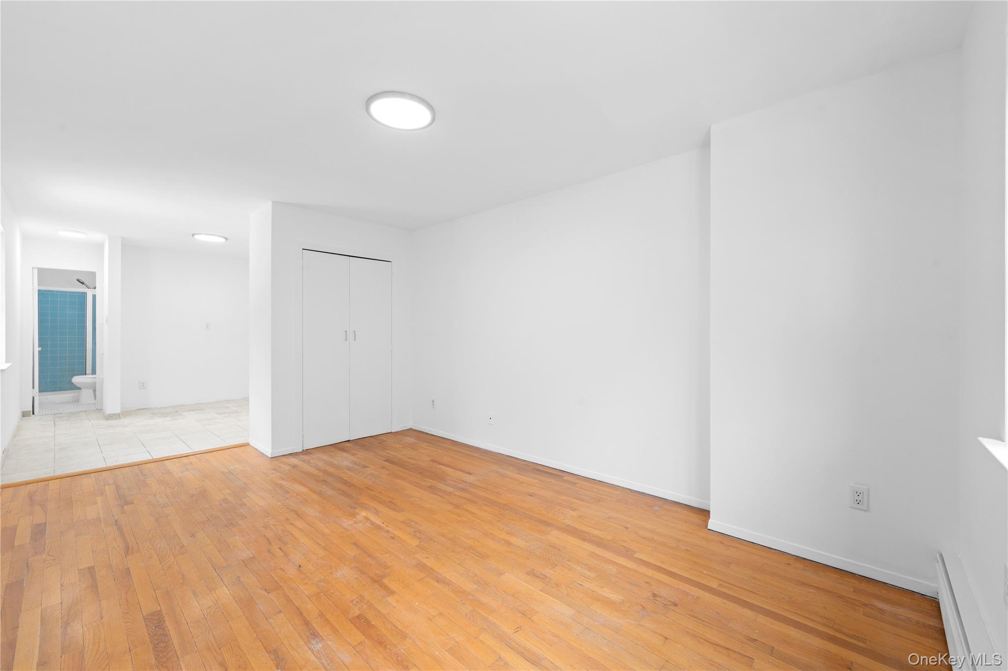 84-30 98th Street Queens, NY 11421 - Photo 18 of 35 a view of empty room with wooden floor