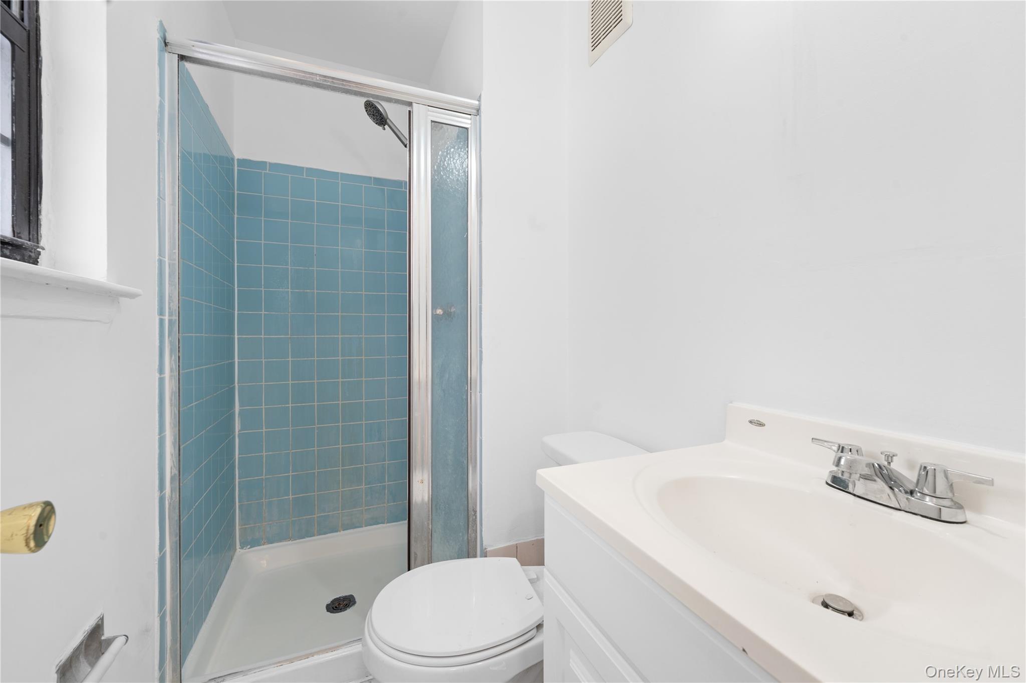 84-30 98th Street Queens, NY 11421 - Photo 19 of 35 a bathroom with a sink a toilet and shower