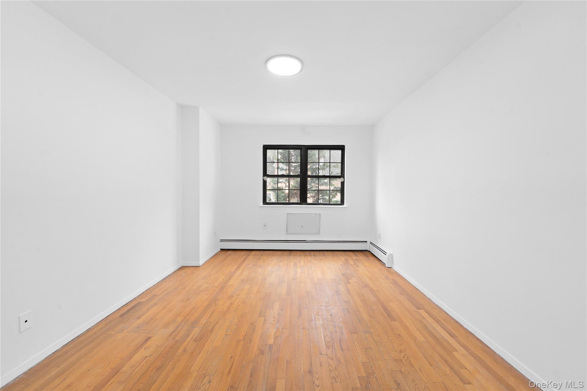 84-30 98th Street Queens, NY 11421 - Photo 24 of 35 wooden floor in a empty room