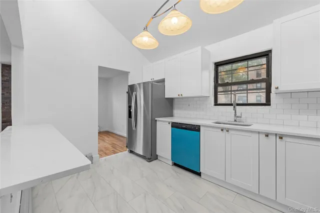 a living room with furniture kitchen view and a flat screen tv