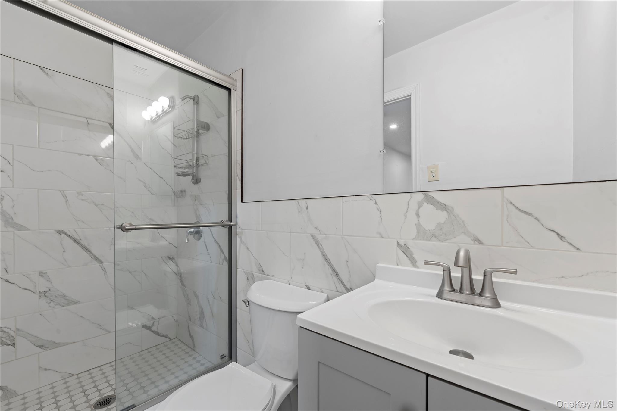 84-30 98th Street Queens, NY 11421 - Photo 31 of 35 a bathroom with a sink toilet and shower