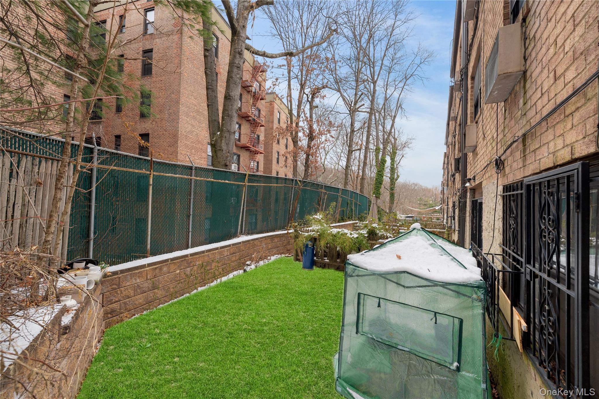 84-30 98th Street Queens, NY 11421 - Photo 35 of 35 a view of backyard with barbeque grill and wooden fence