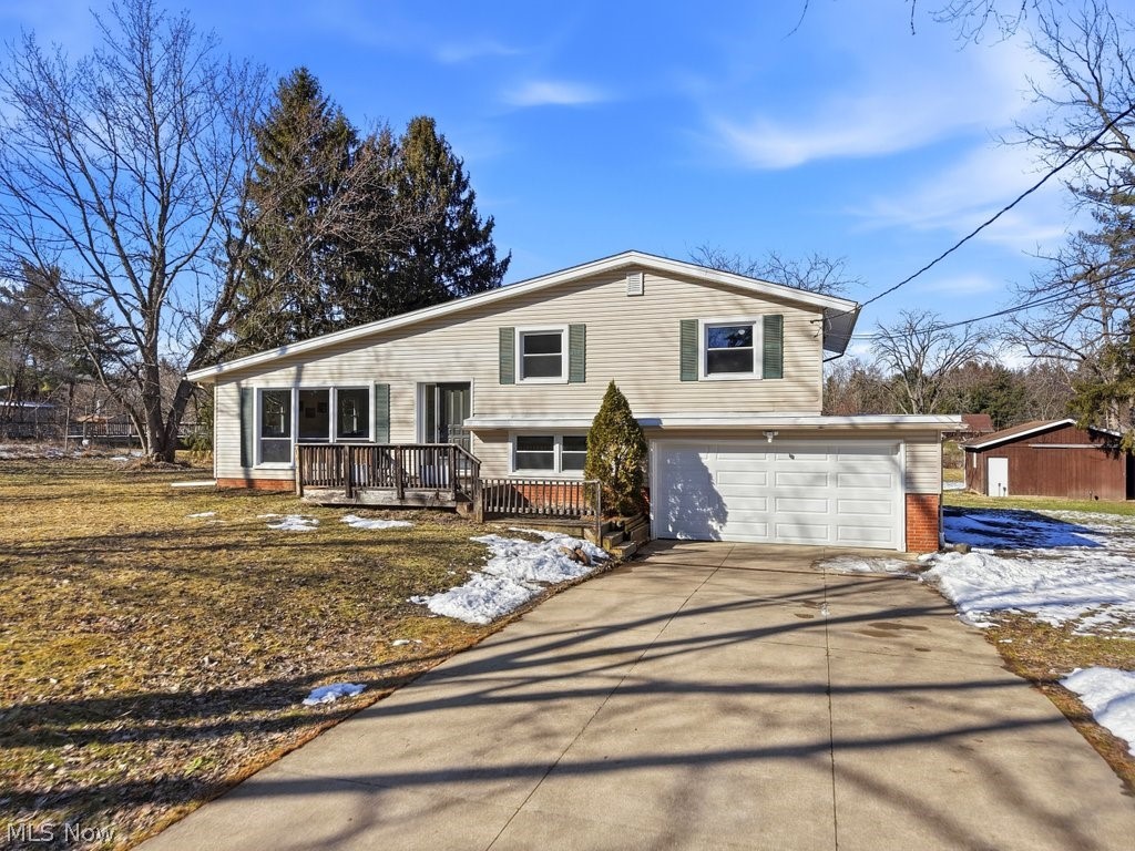 4699 West Bath Road Akron, OH 44333 - Photo 2 of 50 Split level home featuring a garage, concrete driveway and deck.