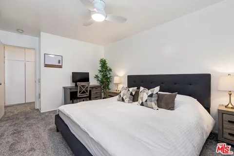 a bedroom with a bed and a flat screen tv