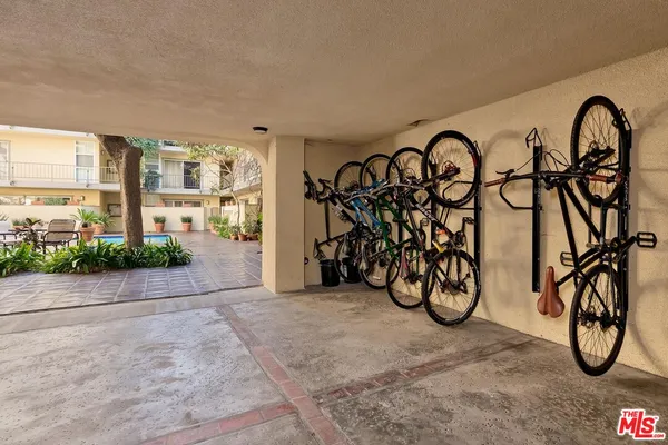 a view of an bike garage with rack and bicycle