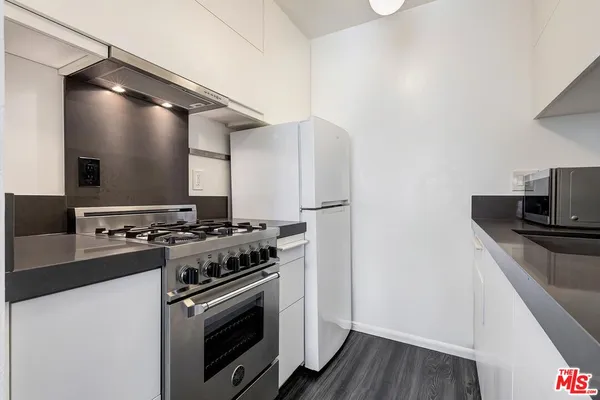 a kitchen with a stove and a refrigerator