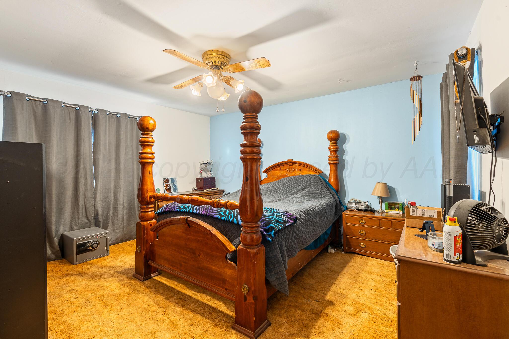 1790 Farm To Market Road 145 Hart, TX 79043 - Photo 11 of 28 a bedroom with bed and a chandelier