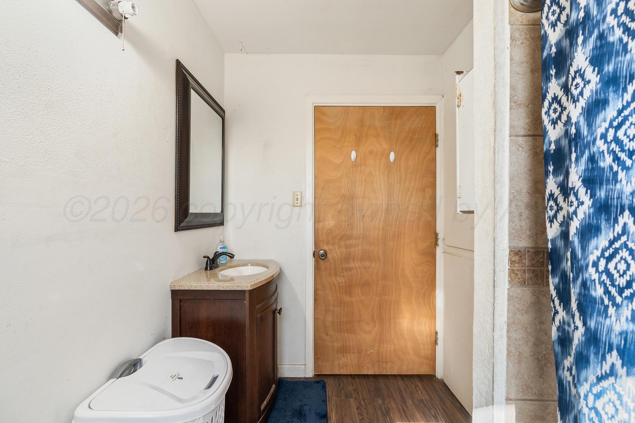 1790 Farm To Market Road 145 Hart, TX 79043 - Photo 15 of 28 a bathroom with a toilet sink vanity and mirror