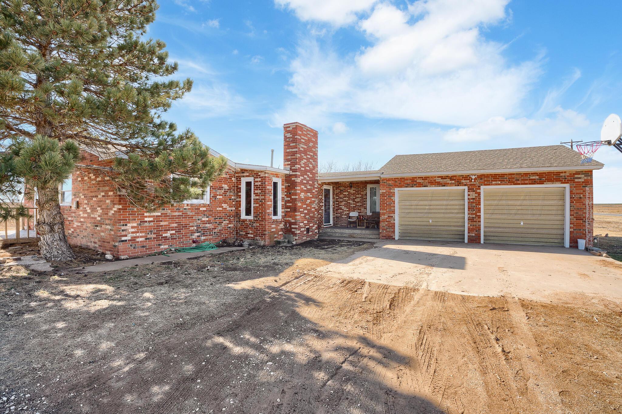 1790 Farm To Market Road 145 Hart, TX 79043 - Photo 2 of 28 a outside view of a house with a yard and garage