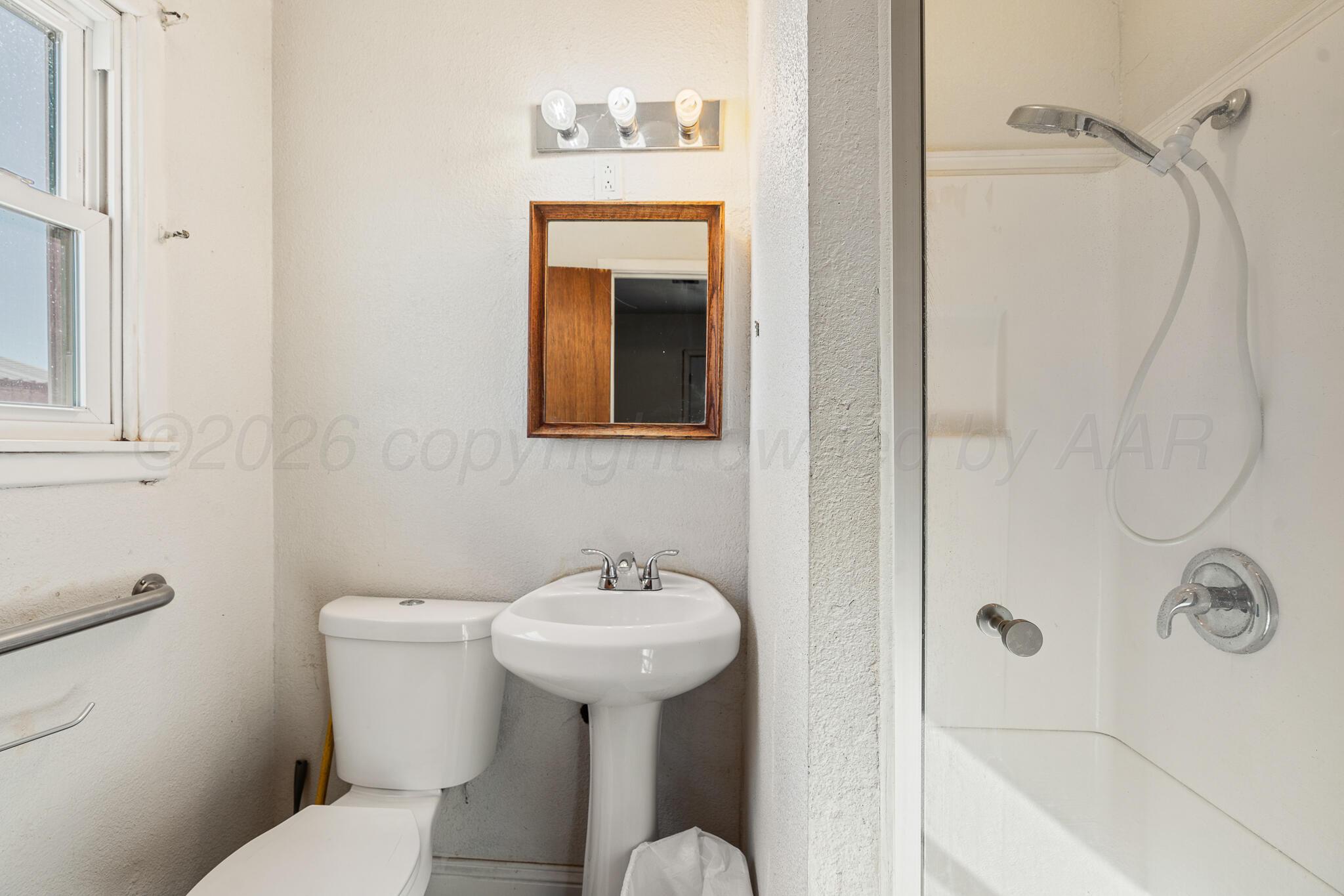 1790 Farm To Market Road 145 Hart, TX 79043 - Photo 24 of 28 a bathroom with a sink toilet and shower