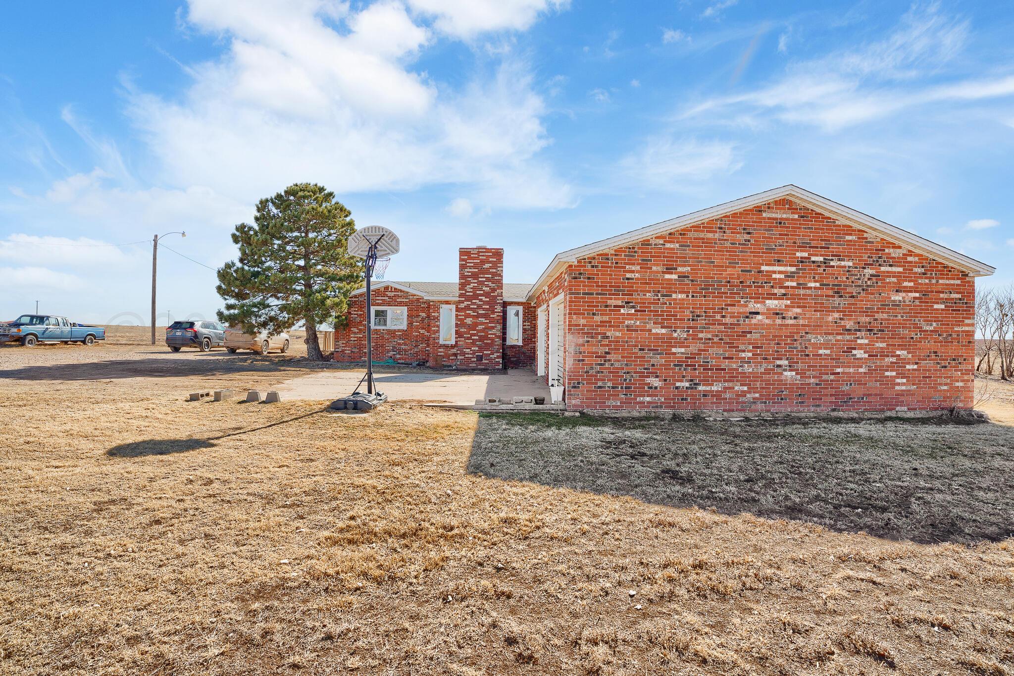 1790 Farm To Market Road 145 Hart, TX 79043 - Photo 5 of 28 a view of a dry yard with a house