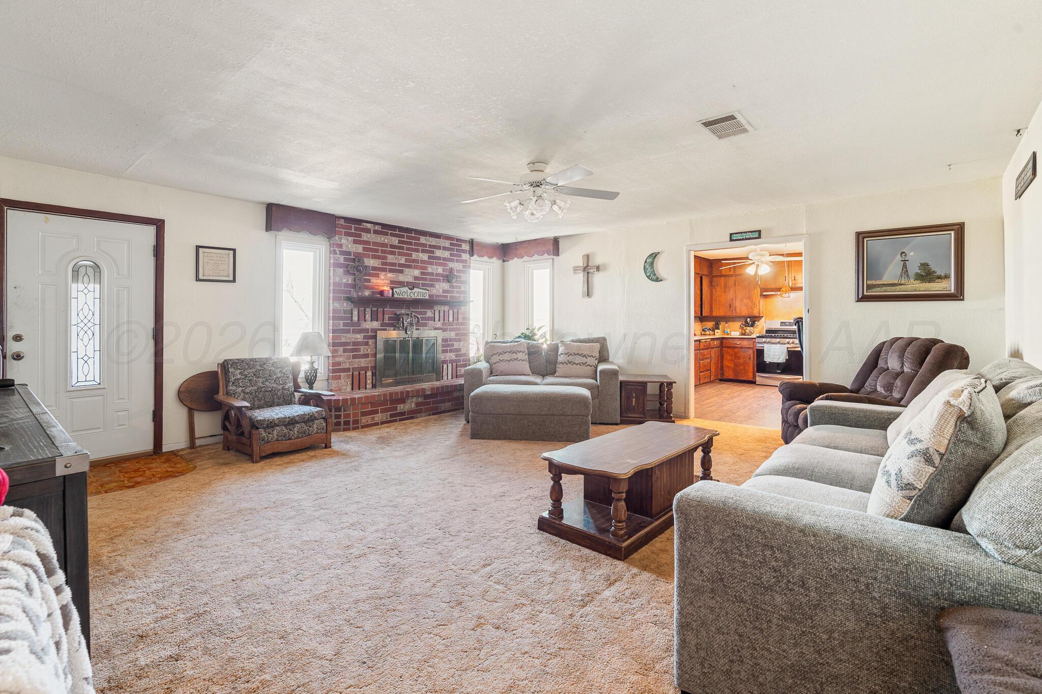 1790 Farm To Market Road 145 Hart, TX 79043 - Photo 8 of 28 a living room with furniture and a large window