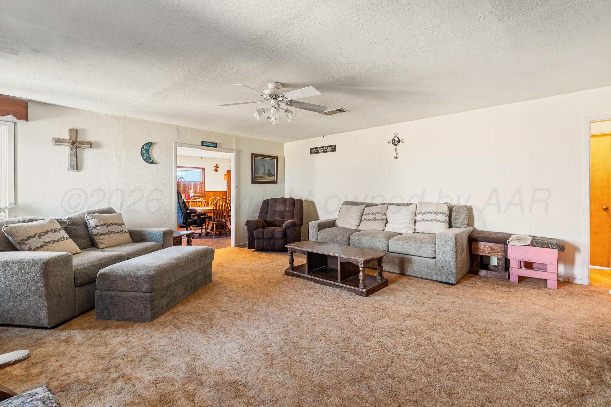 1790 Farm To Market Road 145 Hart, TX 79043 - Photo 10 of 28 a living room with furniture and a large window