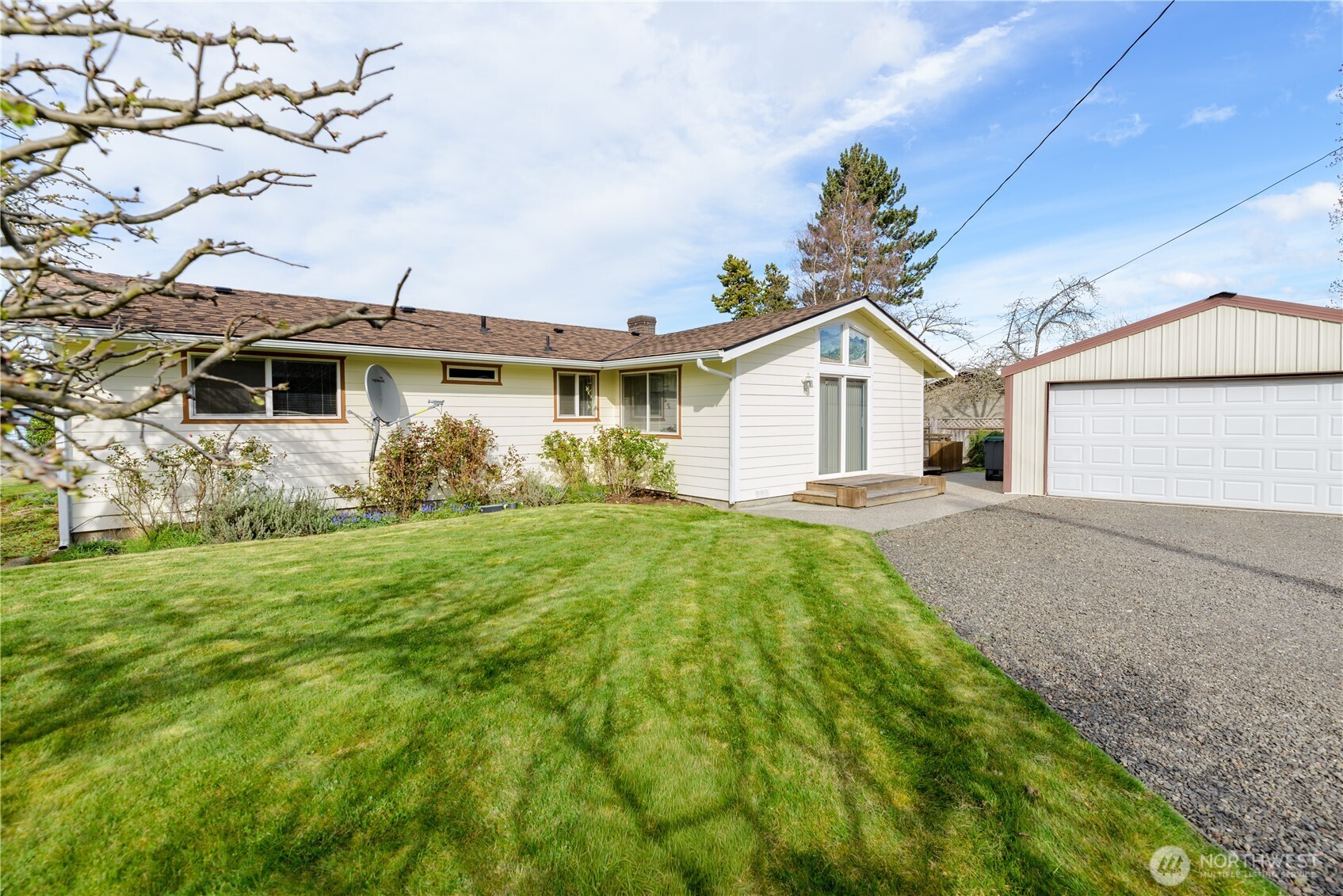 343 West Hemlock Street Sequim, WA 98382 - Photo 1 of 16 a view of a yard in front of a house with plants