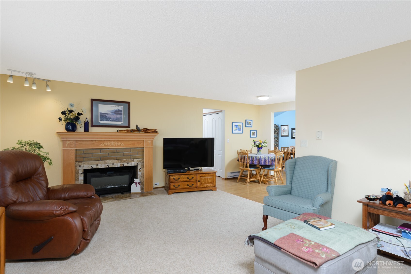 343 West Hemlock Street Sequim, WA 98382 - Photo 6 of 16 a living room with furniture flat screen tv and a fireplace