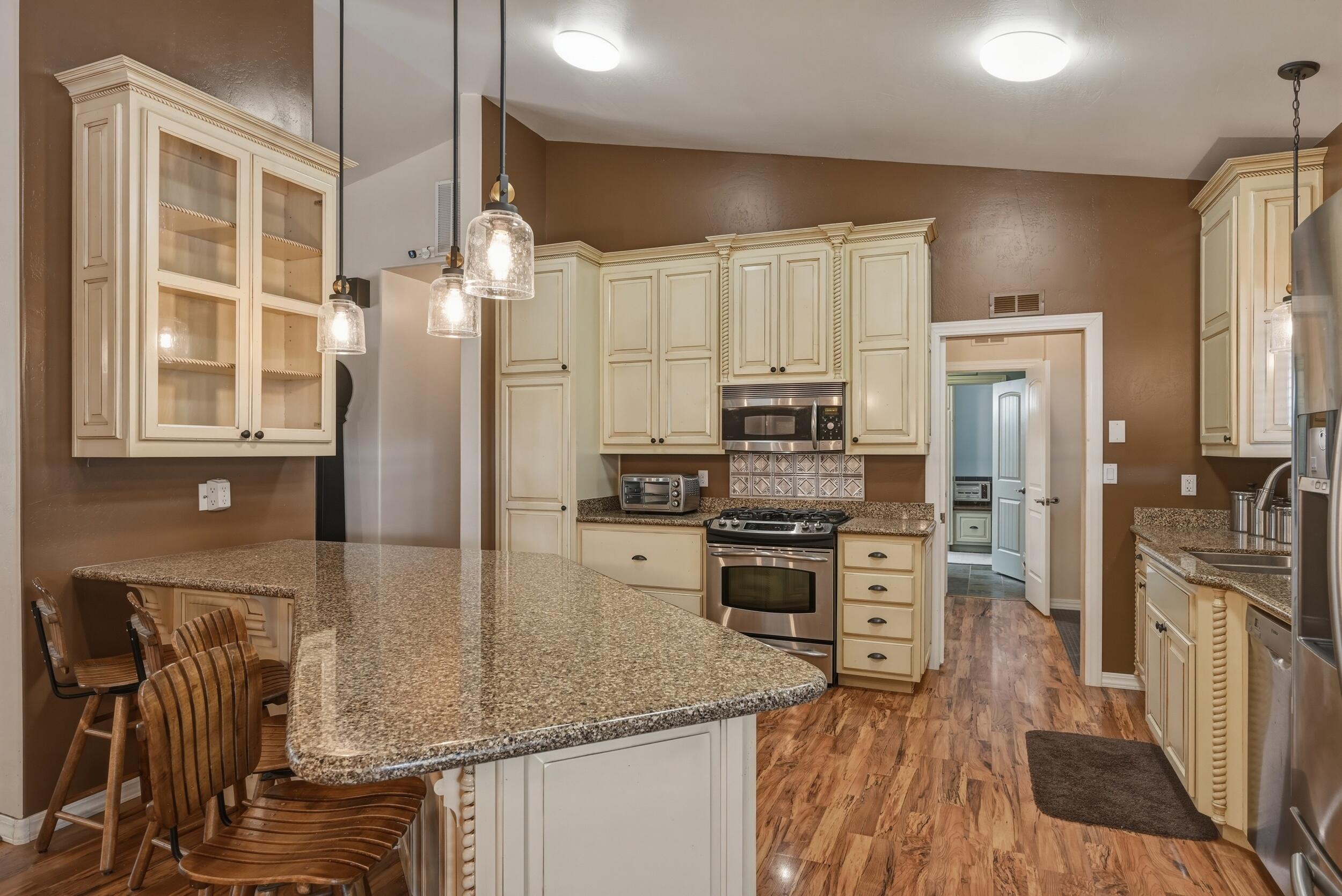 1233 Merzville Road Forest Lakes, AZ 85931 - Photo 11 of 39 a kitchen with stainless steel appliances granite countertop a refrigerator a stove and a sink