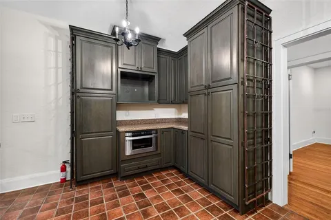 a kitchen with stainless steel appliances granite countertop a refrigerator and a refrigerator