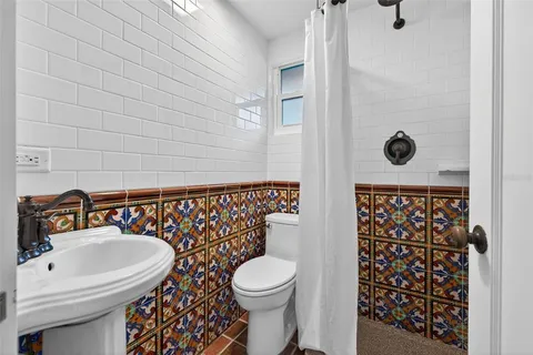 a bathroom with a toilet a sink and a shower