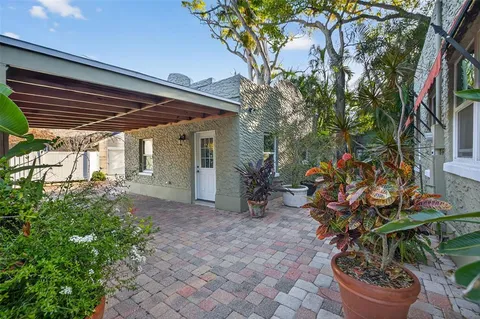 a view of a backyard with plants and a patio