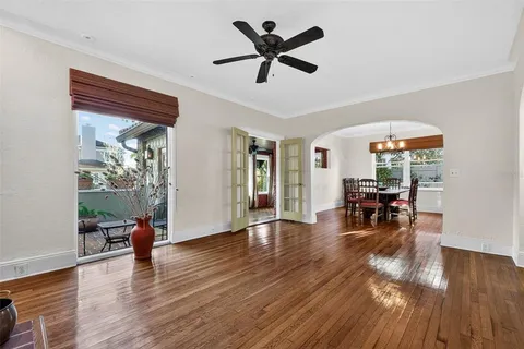 a living room with furniture and a wooden floor