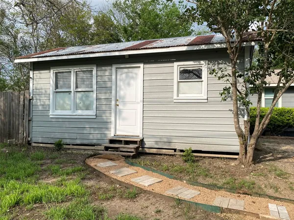a side view of a house with a yard
