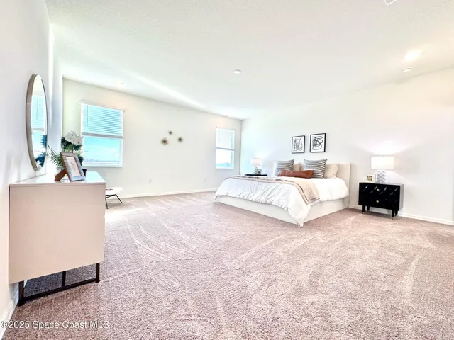 a spacious bedroom with a large bed and a flat screen television