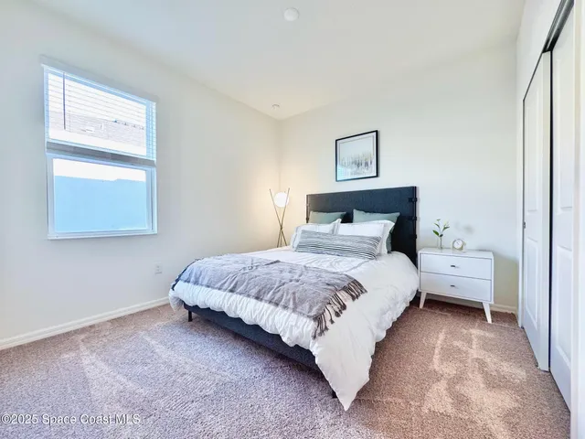 a bedroom with a bed and window