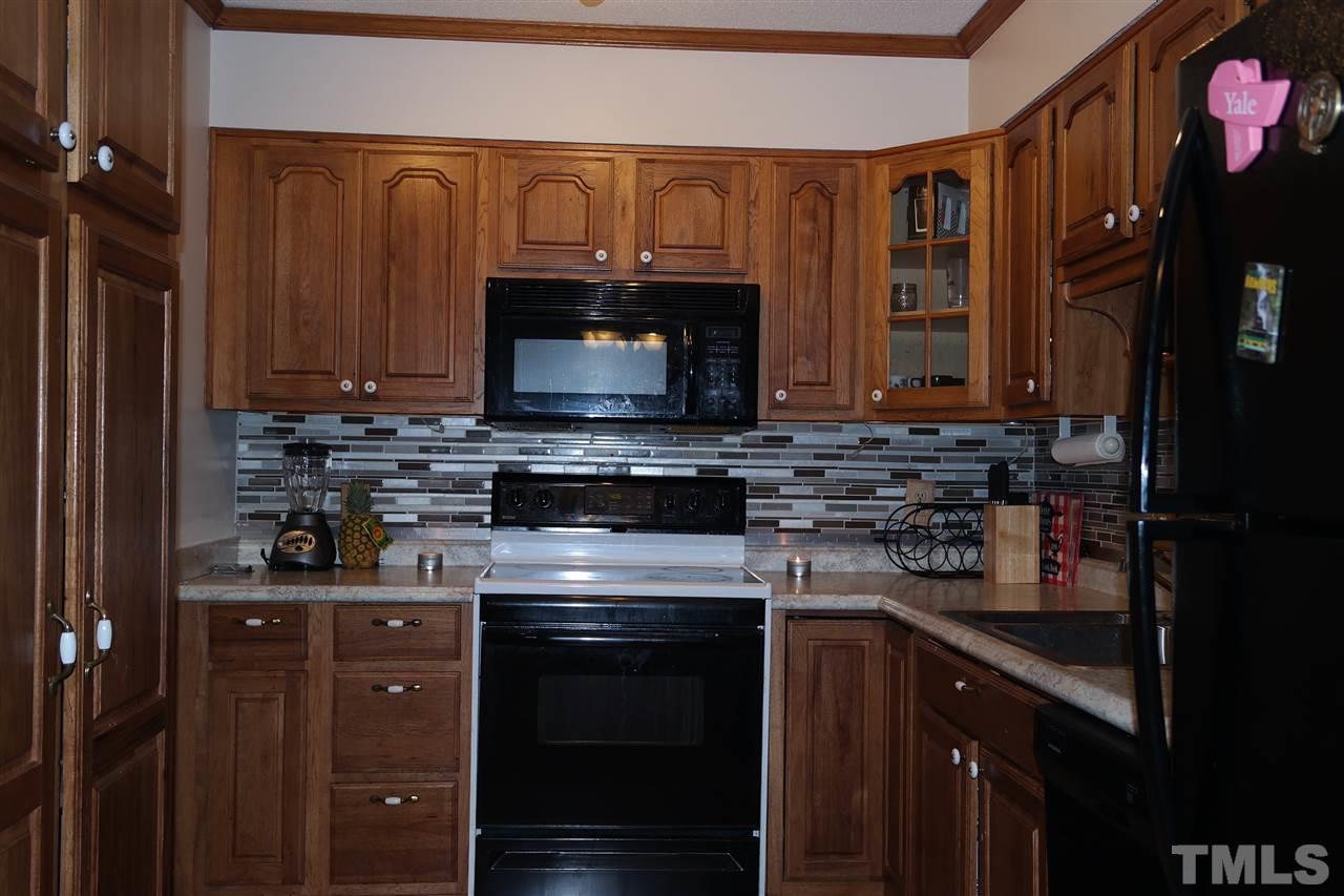 5108 Flint Ridge Place, Unit 5108 Raleigh, NC 27609 - Photo 2 of 15 a kitchen with a stove and a microwave