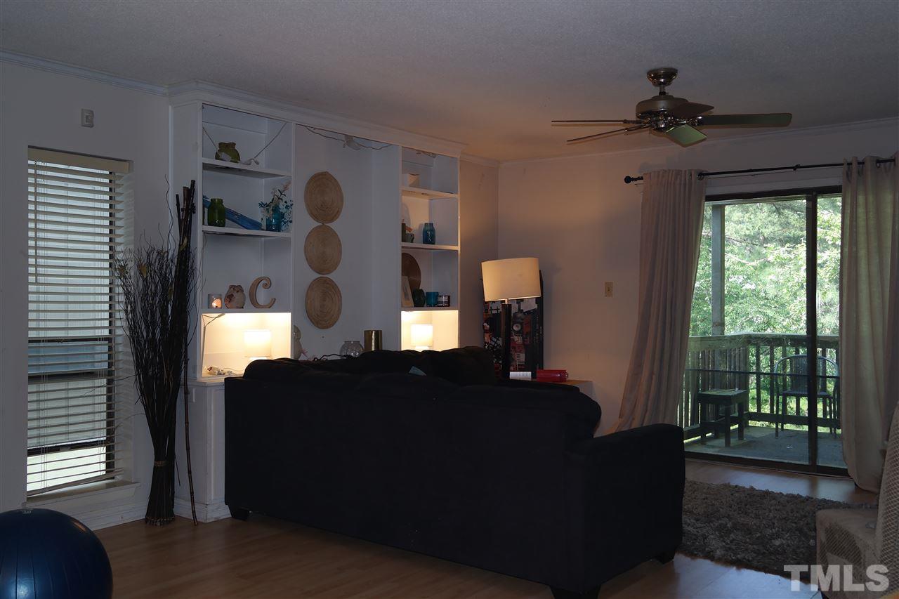 5108 Flint Ridge Place, Unit 5108 Raleigh, NC 27609 - Photo 11 of 15 a living room with furniture and a chandelier