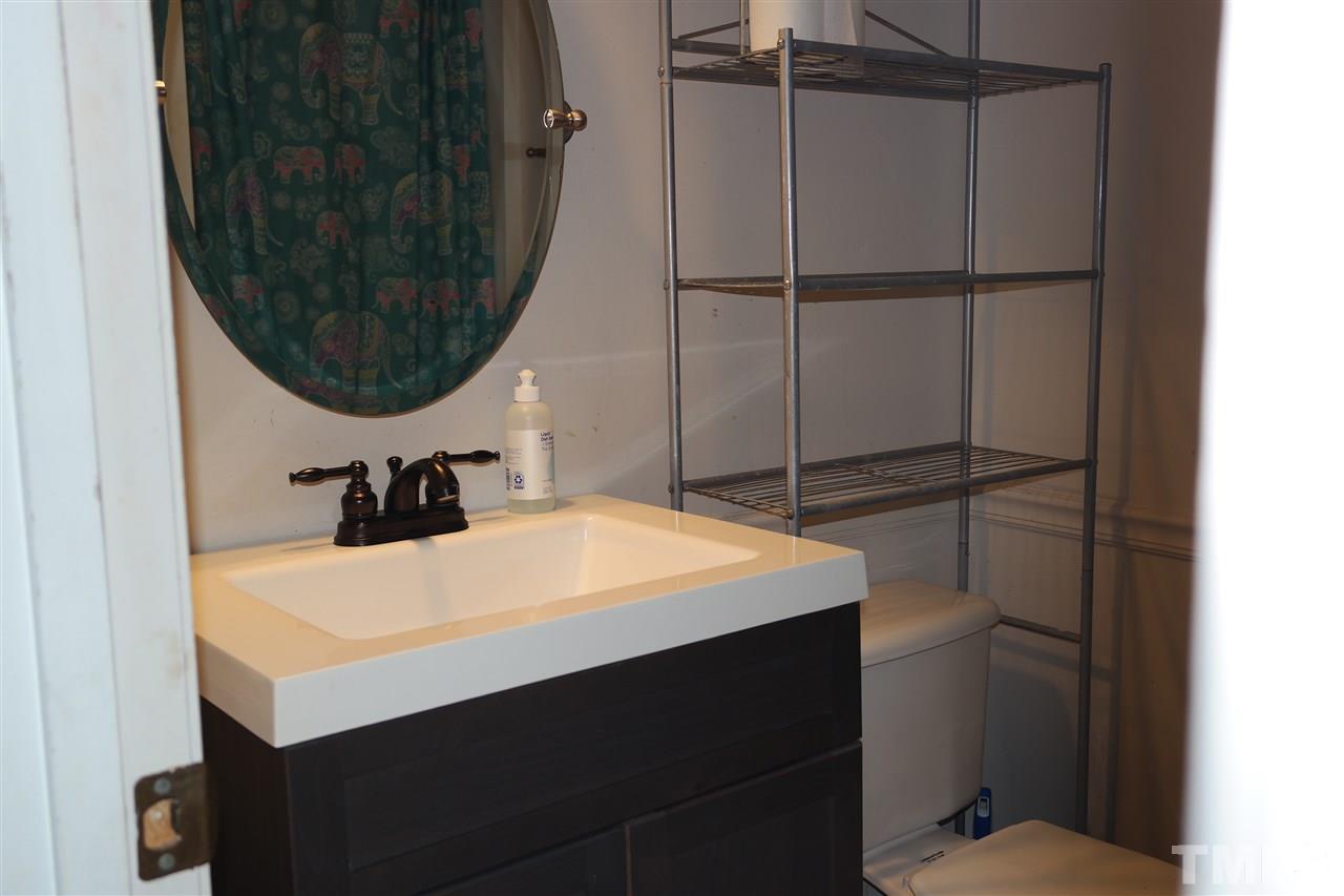 5108 Flint Ridge Place, Unit 5108 Raleigh, NC 27609 - Photo 14 of 15 a bathroom with a sink and a mirror