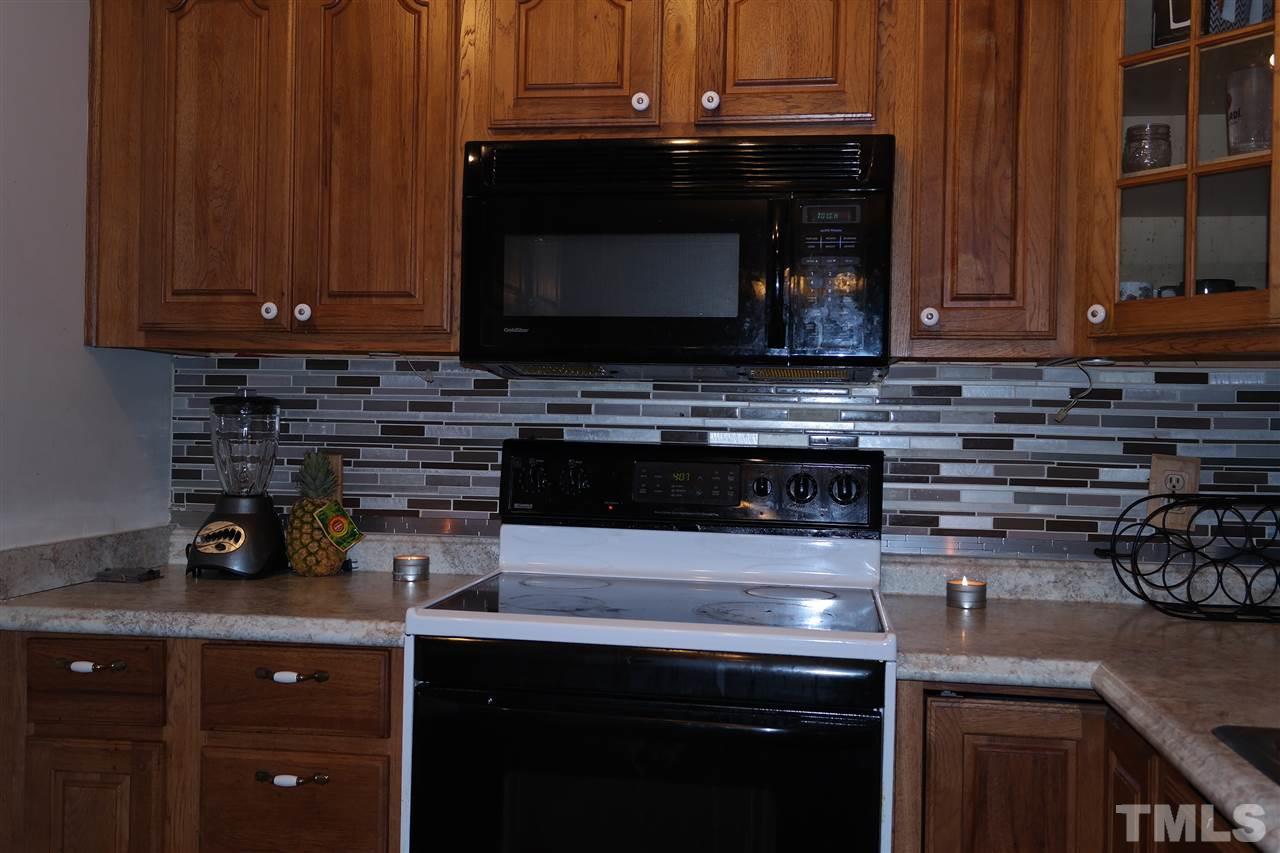 5108 Flint Ridge Place, Unit 5108 Raleigh, NC 27609 - Photo 4 of 15 a kitchen with a stove and a microwave