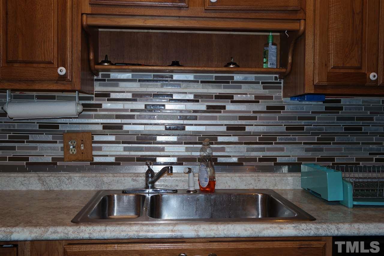 5108 Flint Ridge Place, Unit 5108 Raleigh, NC 27609 - Photo 6 of 15 a kitchen with a stove microwave and sink