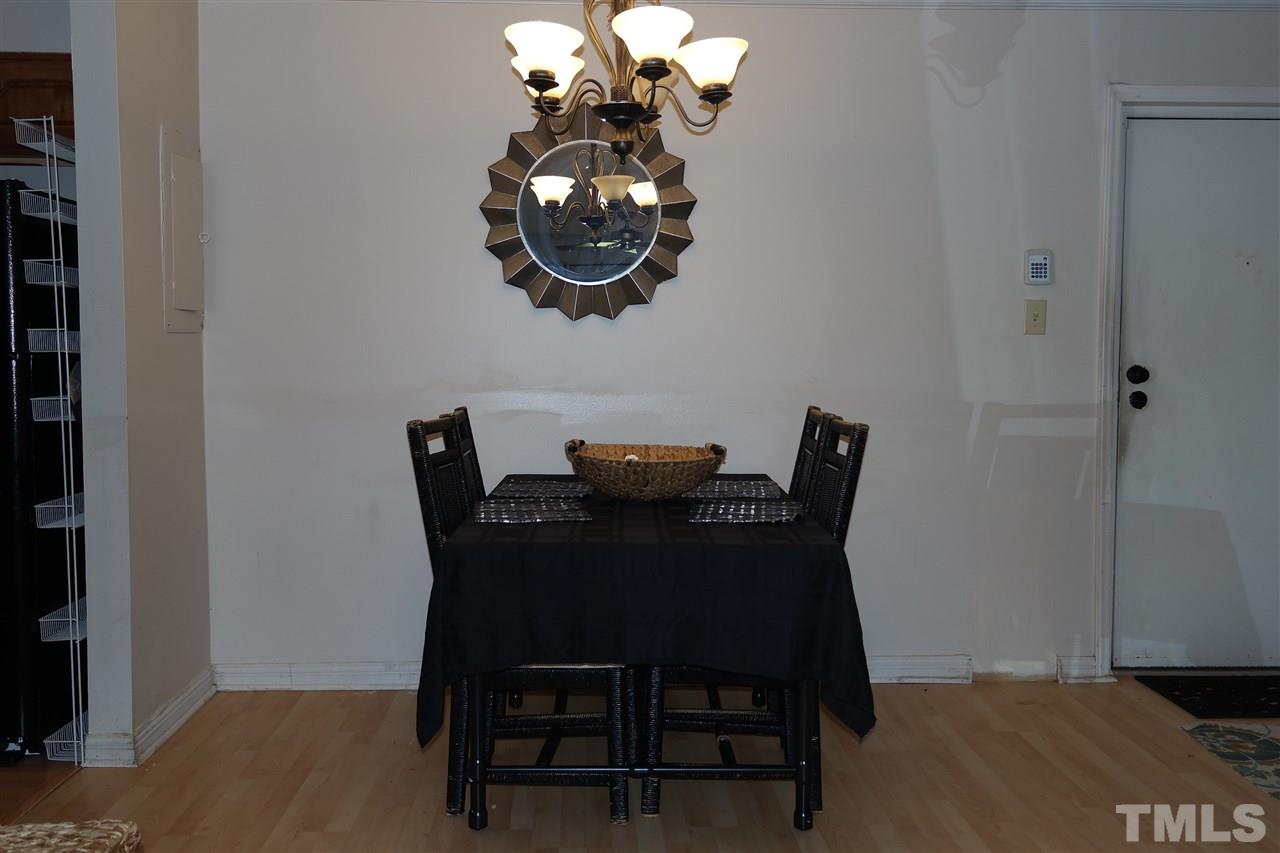 5108 Flint Ridge Place, Unit 5108 Raleigh, NC 27609 - Photo 9 of 15 a dining room with furniture and wooden floor