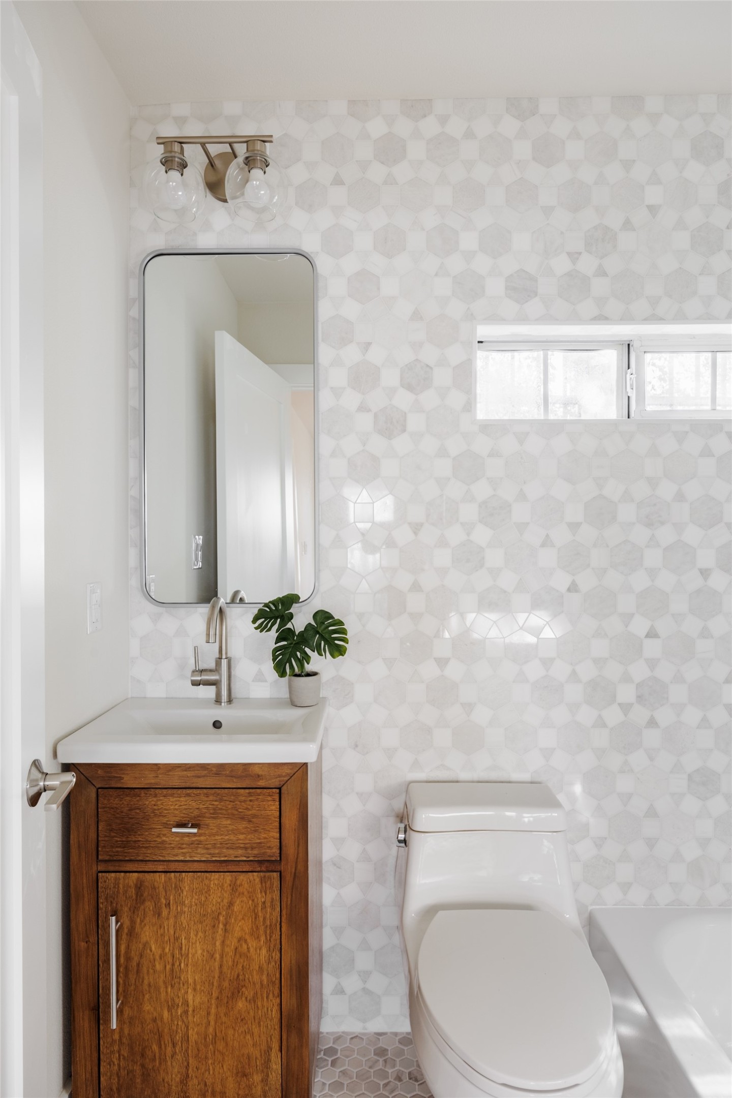 827 Gullett Street Austin, TX 78702 - Photo 20 of 25 a bathroom with a toilet sink and mirror