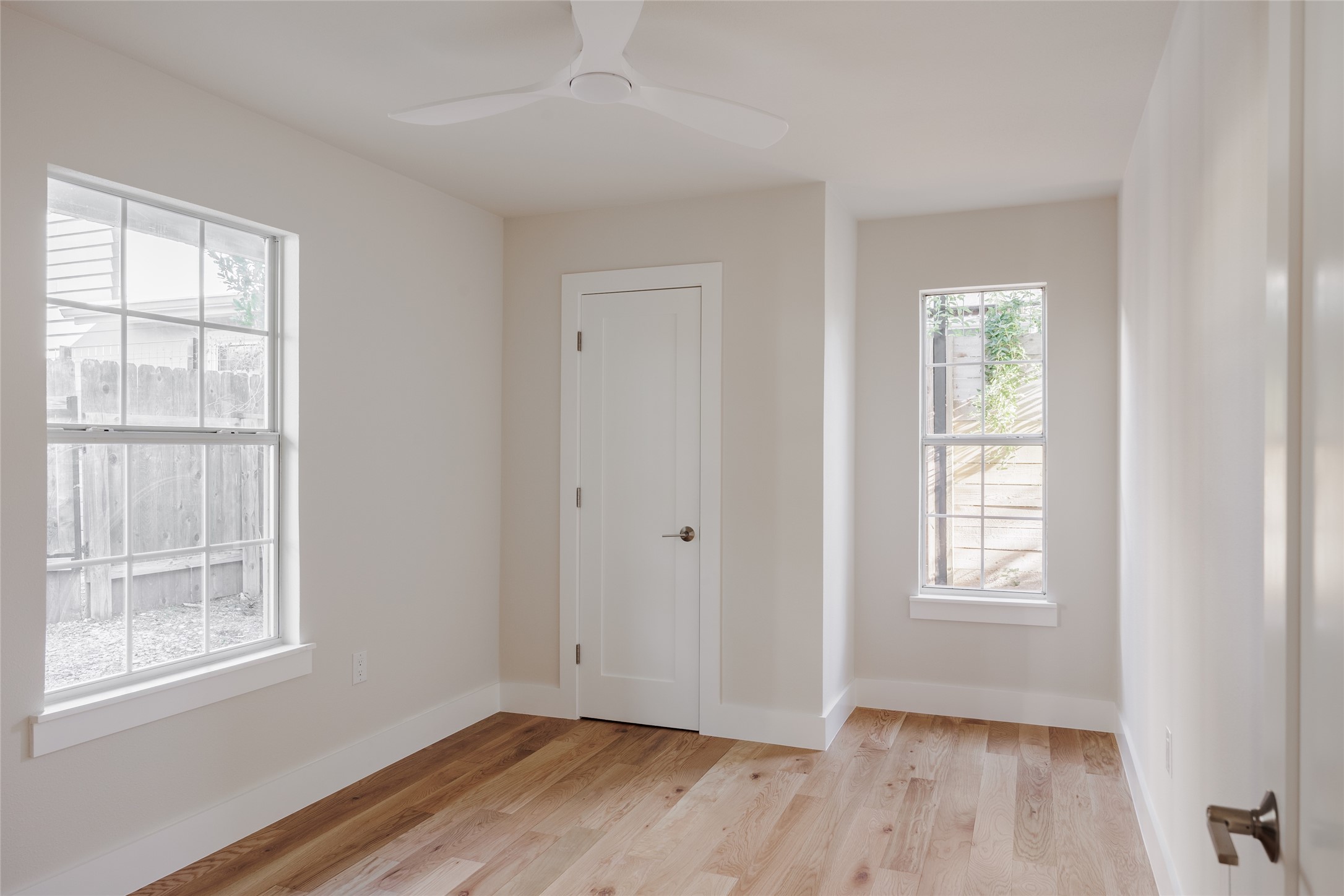 827 Gullett Street Austin, TX 78702 - Photo 21 of 25 a view of an empty room with wooden floor and a window