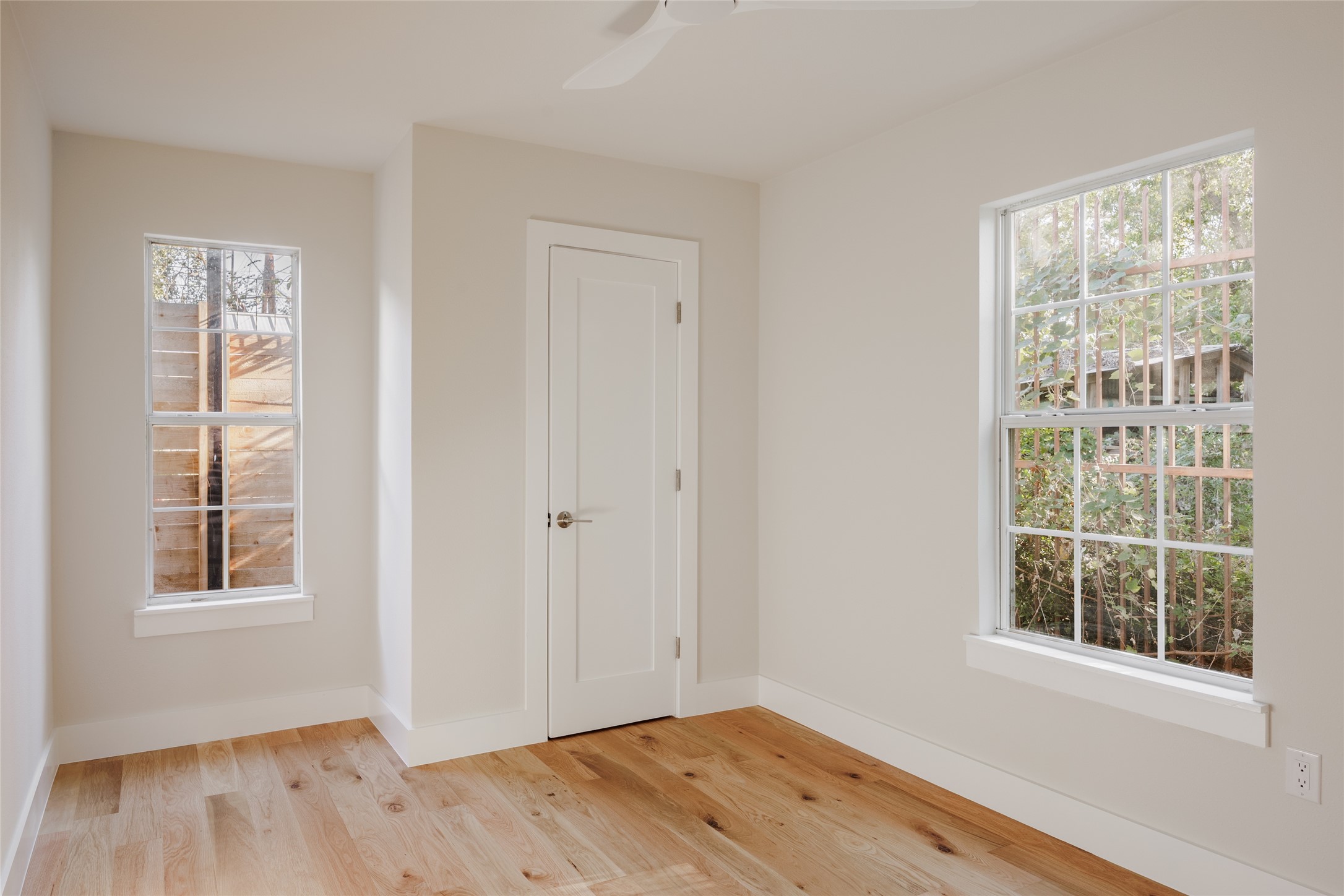 827 Gullett Street Austin, TX 78702 - Photo 22 of 25 a view of empty room with wooden floor and fan